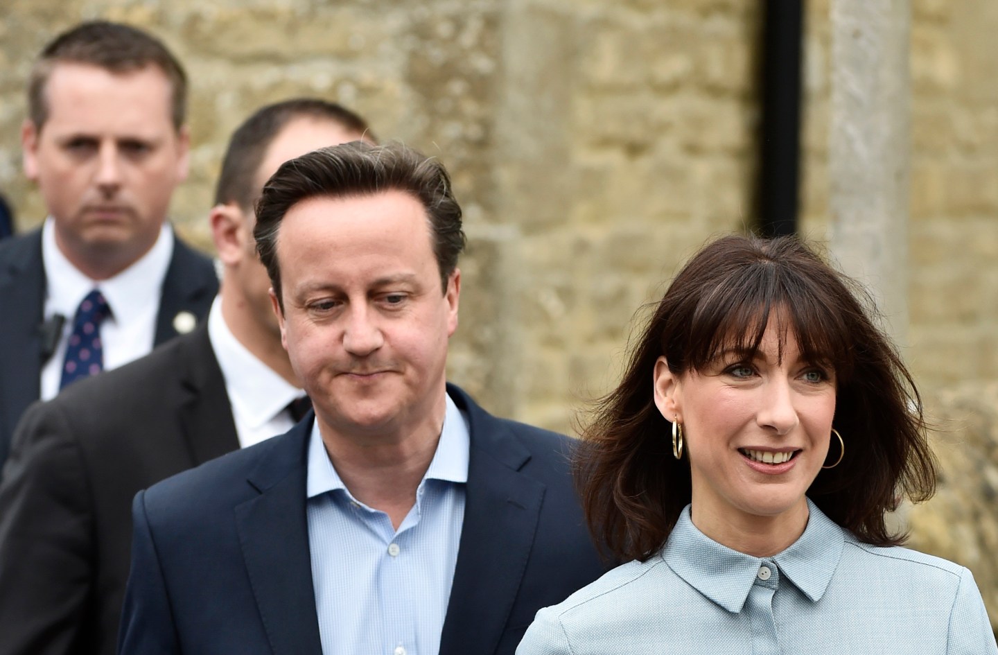 Britain's Prime Minister David Cameron and his wife Samantha leave a polling station after voting in Spelsbury, central England
