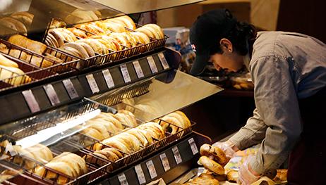 A Safeway baker puts out fresh bagels  at the store in Wheaton Maryland