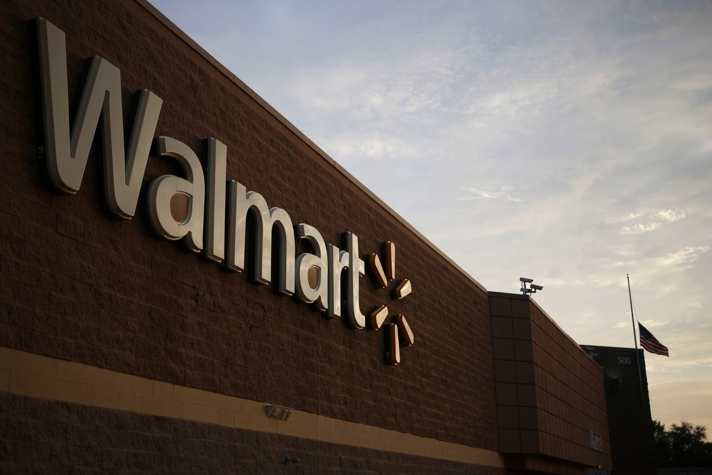 Signage is displayed on the exterior of a Wal-Mart Stores, Inc. retail location in Shelbyville, Kentucky, U.S. on Monday, May 18, 2015. Wal-Mart is expected to release quarterly earnings on Tuesday, May 19. Photographer : Luke Sharrett / Bloomberg