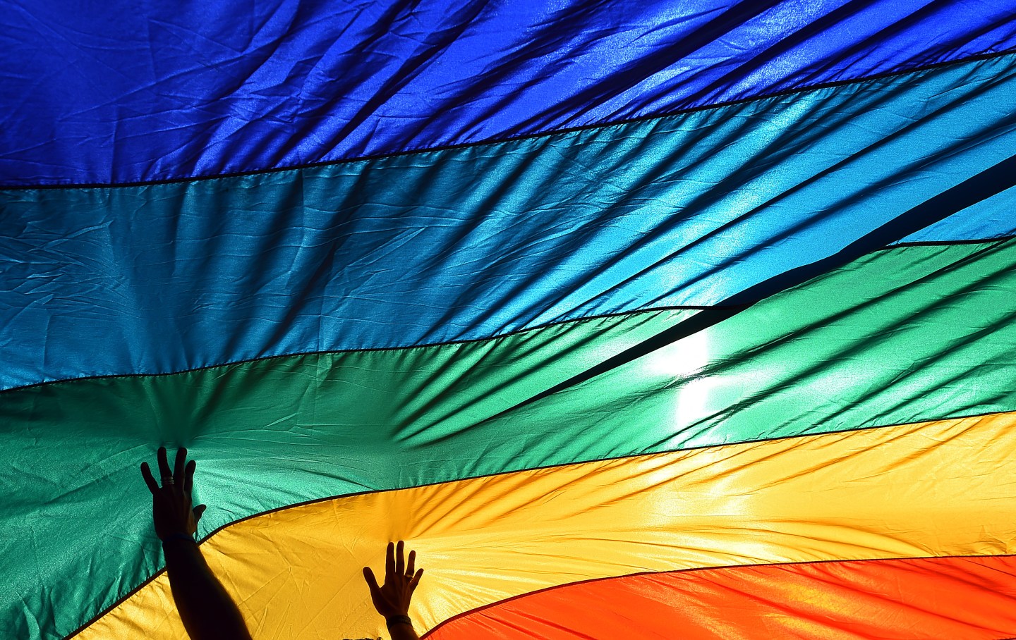 WASHINGTON, DC - APRIL 28: A man reaches out to a large rainbo