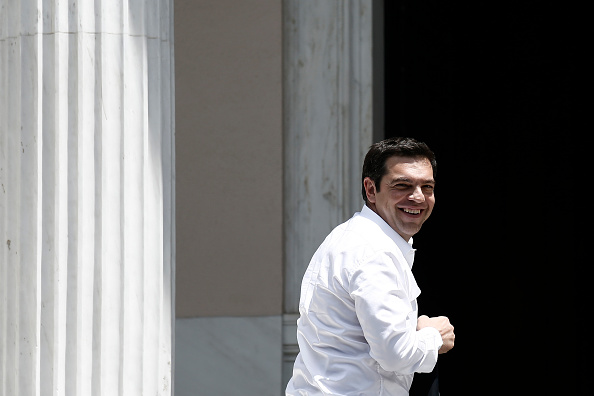Alexis Tsipras, Greece's prime minister, smiles as he arrives at his office after returning from Brussels meetings in Athens, Greece, on Thursday, June 4, 2015. After meeting in Brussels with European Commission President Jean-Claude Juncker and Dutch Finance Minister Jeroen Dijsselbloem, who also heads the group of his euro-area counterparts, Tsipras stuck to his position that any basis for an accord must be a Greek proposal. Photographer: Kostas Tsironis/Bloomberg *** Local Caption *** Alexis Tsipras