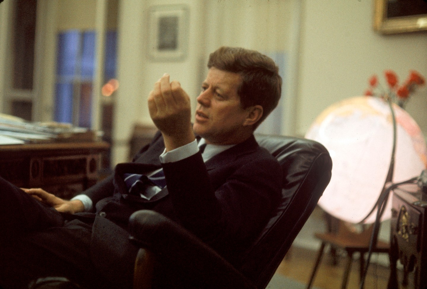 Pres. John F. Kennedy sitting in his White House o