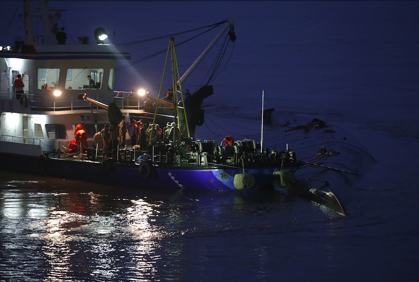 A rescue ship and workers are seen around a sunken ship in the Jianli section of Yangtze River, Hubei province