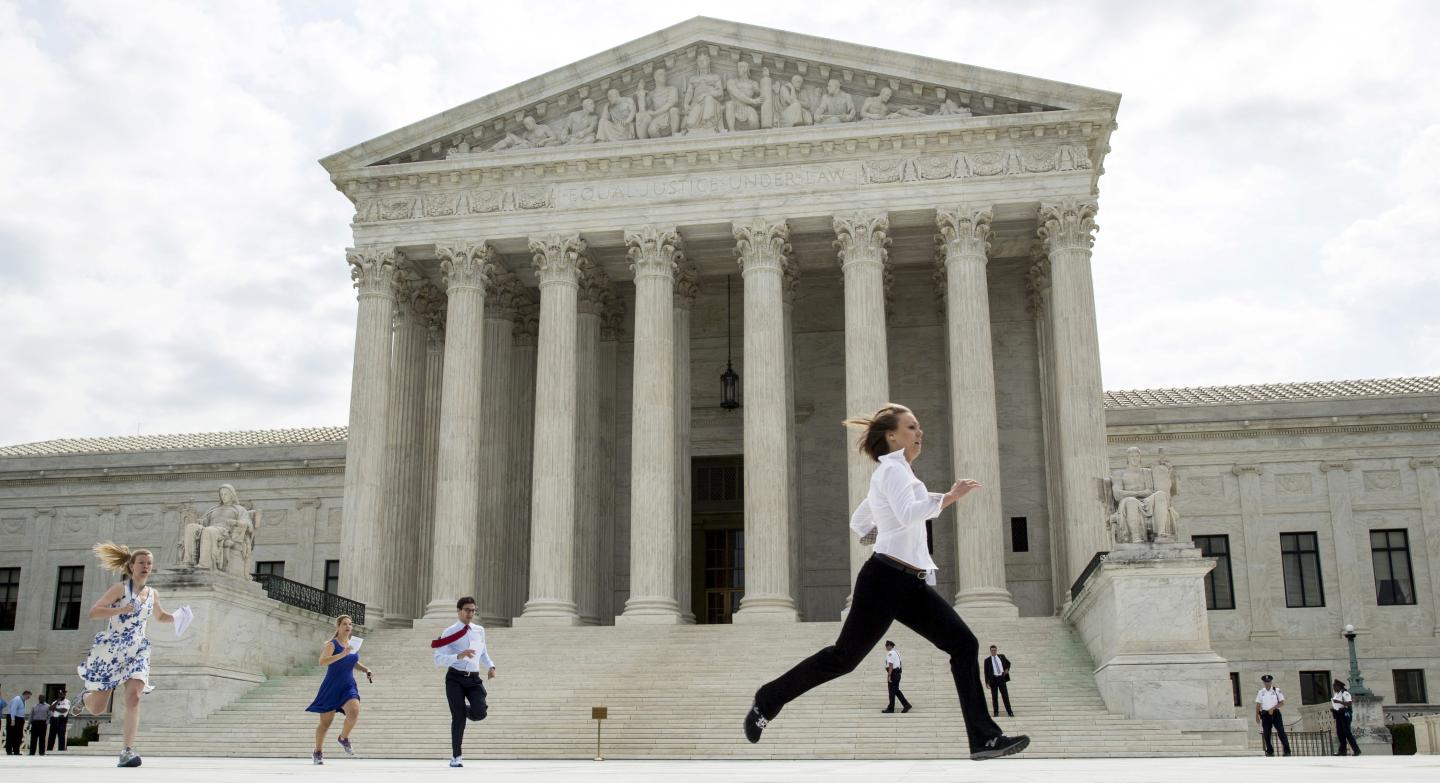 Interns with media organizations run with the decision upholding the Affordable Care Act at the Supreme Court in Washington