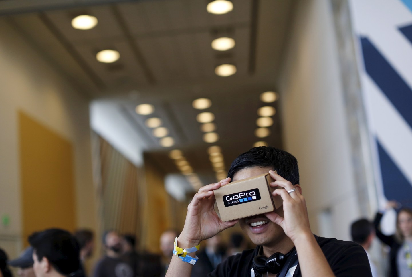 A conference attendee looks through "Cardboard," a viewer that enables the user to view content from a smart phone in 3D, during the Google I/O developers conference in San Francisco