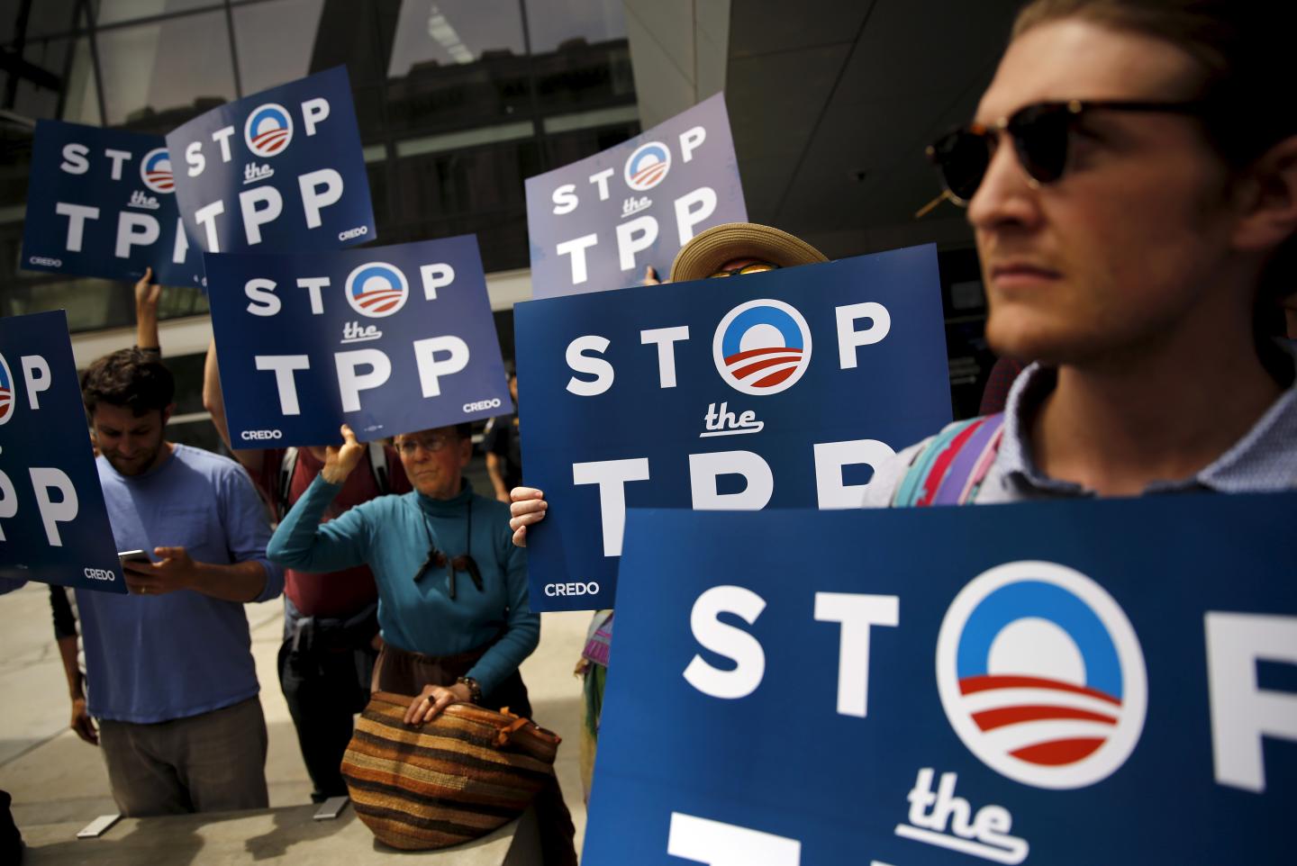 A group of demonstrators protesting the Trans-Pacific Partnership gather at the Federal Buileing in San Francisco