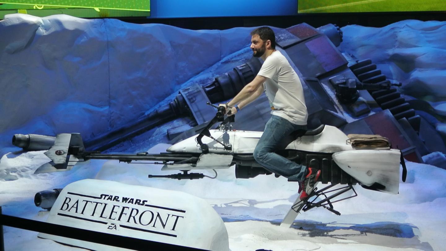 A fan rides a speeder bike at Electronic Arts' Star Wars Battlefront booth at E3 2015