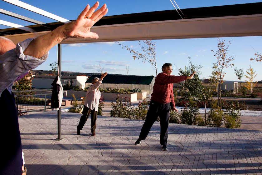 Residents of Spain's Trabensol senior housing cooperative exercise at one of the facility's common areas.
