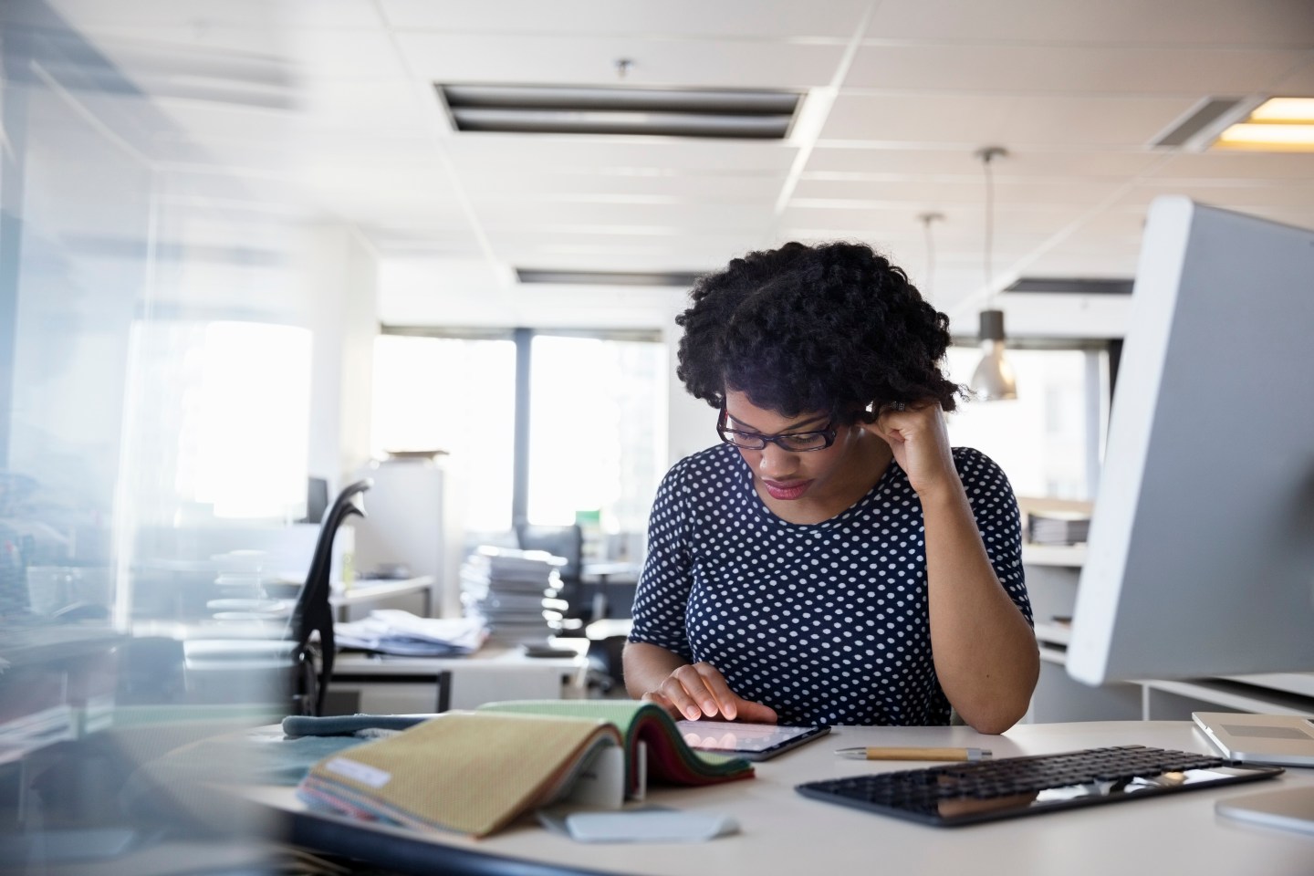 19 Apr 2015 --- Focused interior designer using digital tablet office desk --- Image by © Hero Images/Corbis