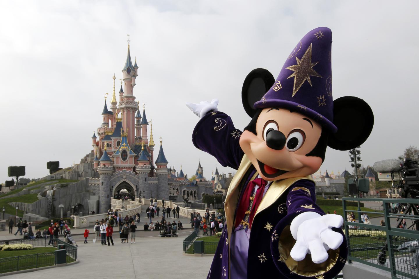 Disney character Mickey poses in front o