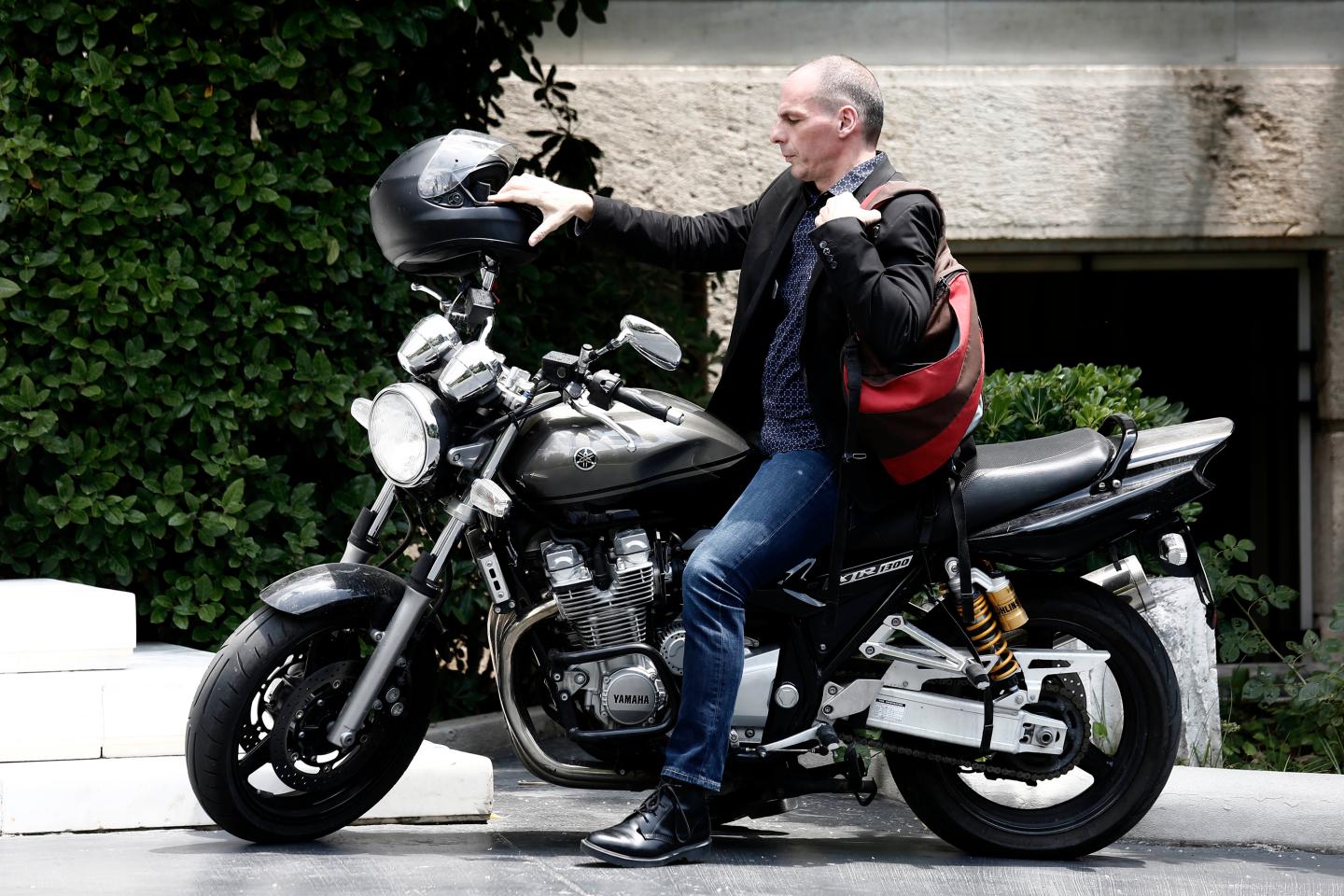 Yanis Varoufakis, Greece's finance minister, arrives on a motorbike for a government meeting at Maximos Mansion in Athens, Greece, on Sunday, June 28, 2015. Greek bank executives and European officials are warning of an imminent cash crunch or bank shutdown after talks on a new aid package collapsed. Photographer: Kostas Tsironis/Bloomberg *** Local Caption *** Yanis Varoufakis