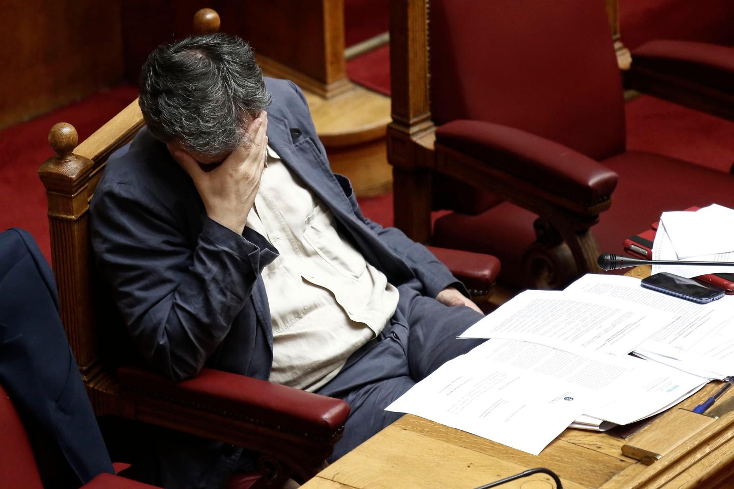Euclid Tsakalotos, Greece's finance minister, pauses while attending a parliamentary meeting in Athens, Greece, on Wednesday, July 15, 2015. Parliament will vote Wednesday night on the measures Greece's creditors demanded as a condition for aid as capital controls ravage an economy that has already shrunk by a quarter since 2009. Photographer: Kostas Tsironis/Bloomberg *** Local Caption *** Euclid Tsakalotos