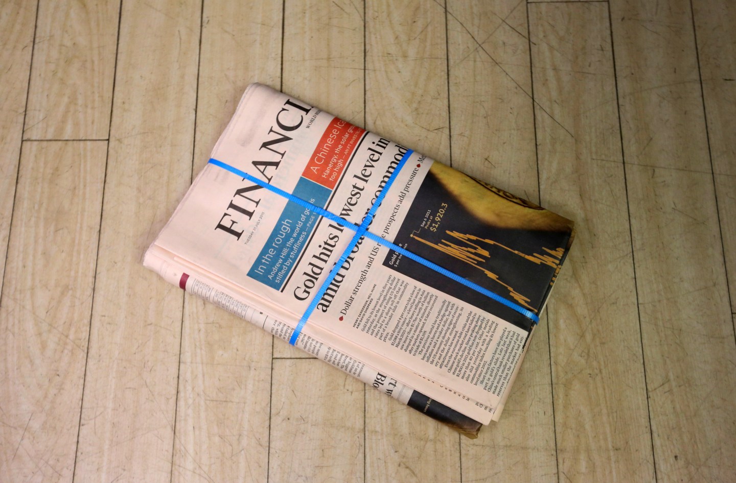 Copies of the Financial Times newspaper sit on the floor at a newsagent in Danbury, Essex, U.K., on Tuesday, July, 21, 2015. Pearson Plc, owner of the Financial Times newspaper, is exploring a sale of the newspaper after receiving interest from potential buyers, according to people familiar with the matter. Photographer: Chris Ratcliffe/Bloomberg