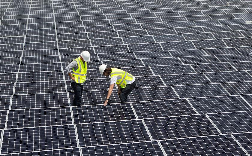 Technicians working on solar panels