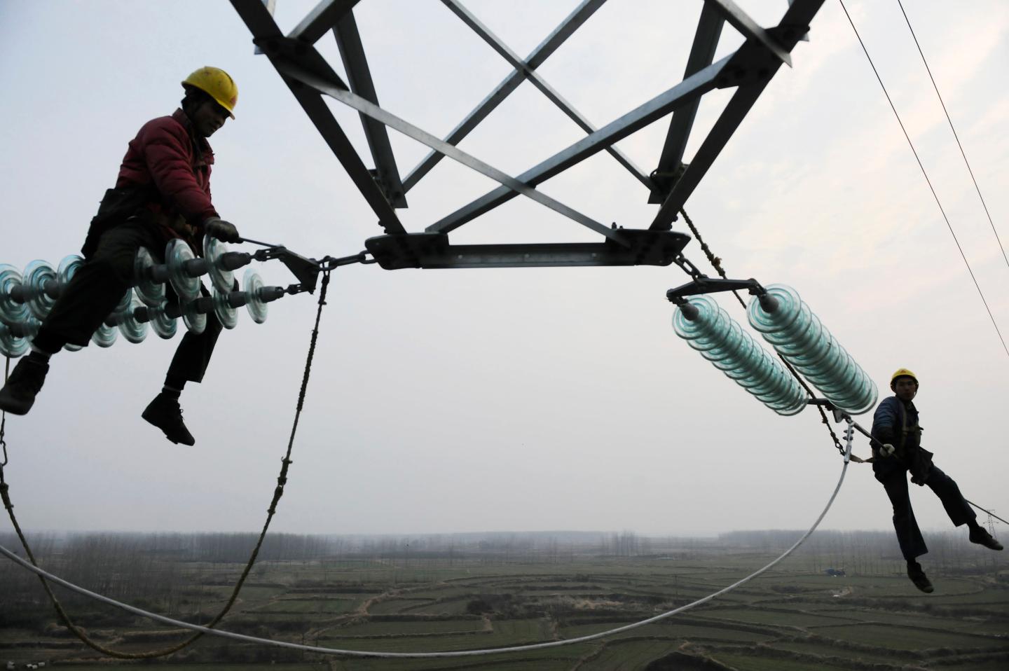 Employees work on a pylon in Chuzhou