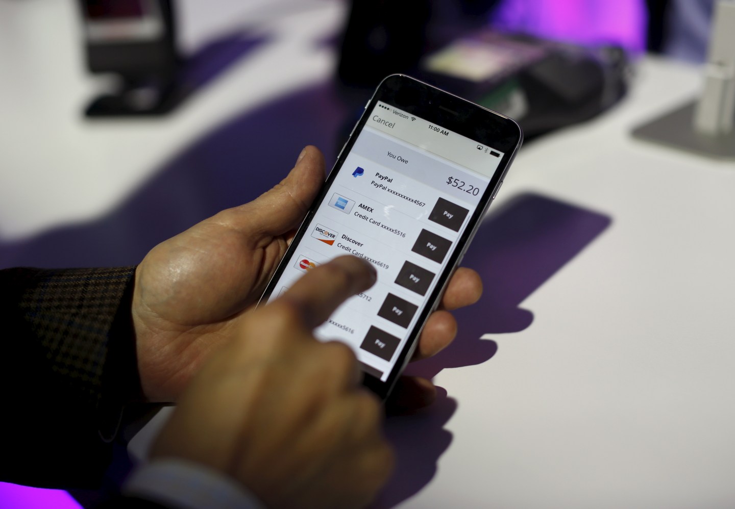 A payment is made on a mobile device during a PayPal demonstration at Terra Gallery in San Francisco