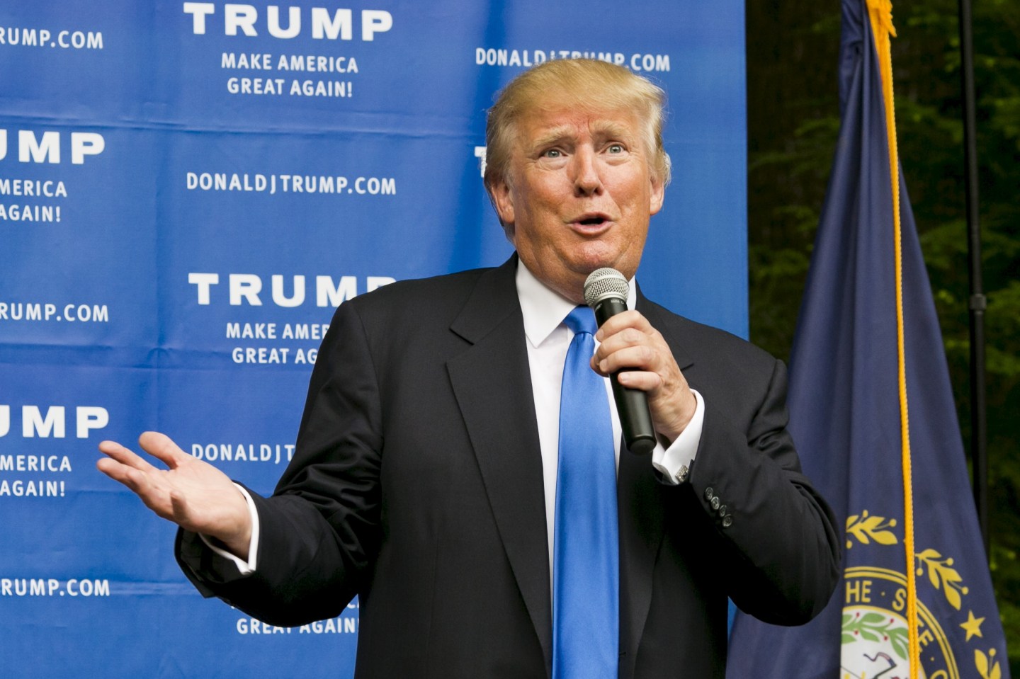 Businessman and Republican presidential candidate Donald Trump speaks to supporters during a back-yard reception in Bedford