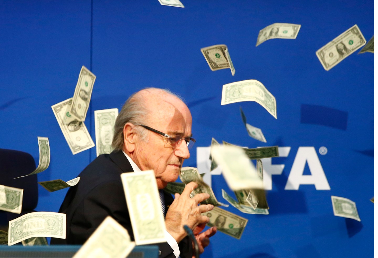 Banknotes are thrown at FIFA President Blatter as he arrives for a news conference after the Extraordinary FIFA Executive Committee Meeting at the FIFA headquarters in Zurich
