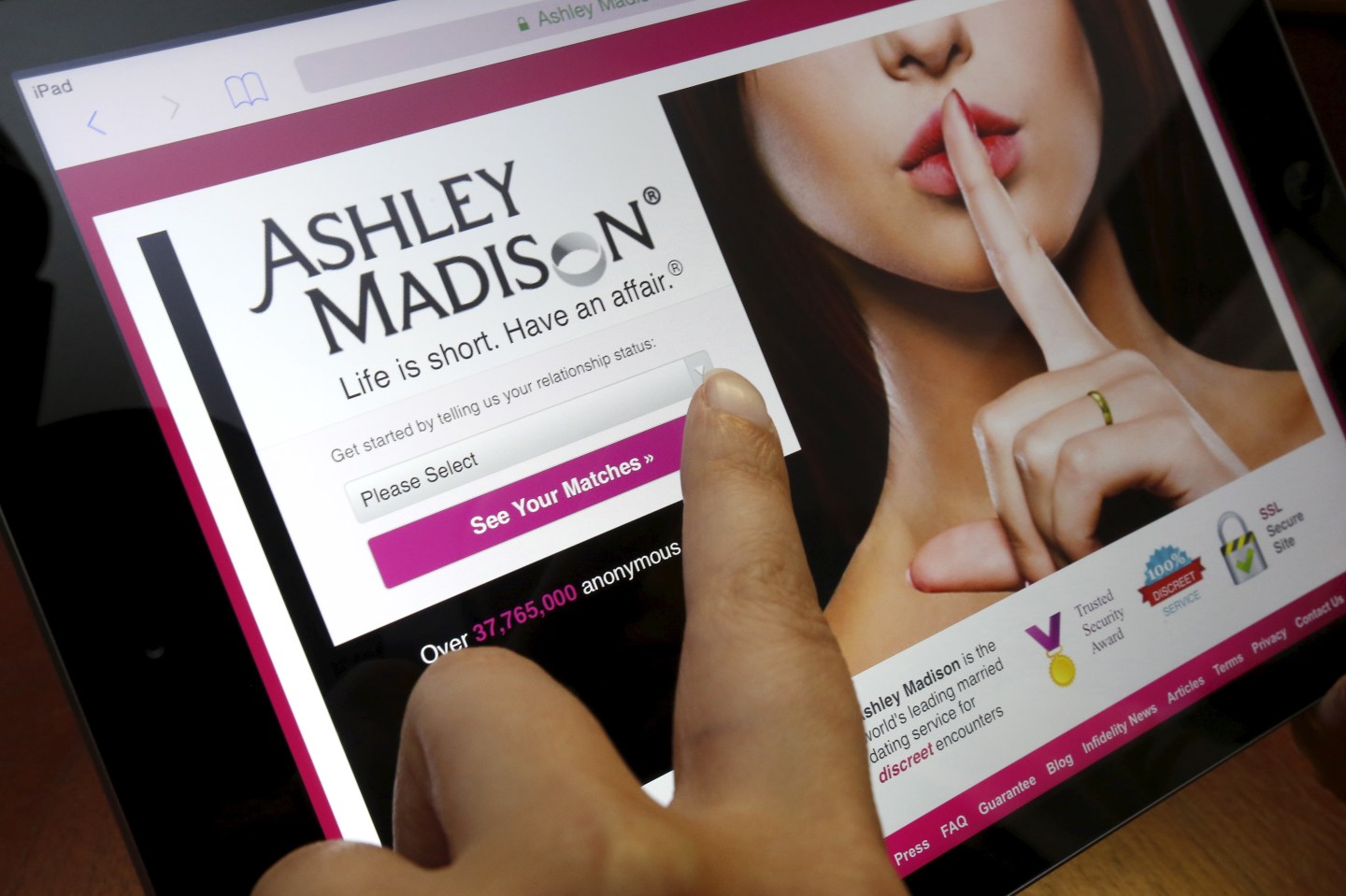Homepage of Ashley Madison website displayed on iPad, in photo illustration taken in Ottawa