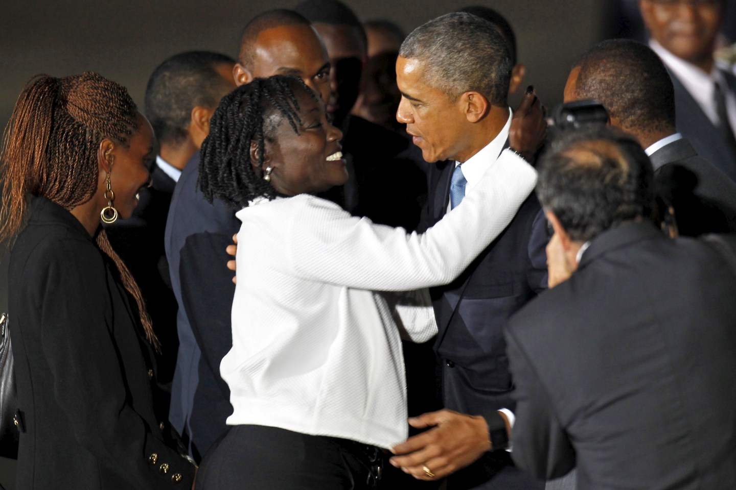 U.S. President Barack Obama embraces his half-sister Auma Obama as he arrives aboard Air Force One at Jomo Kenyatta International Airport in Nairobi