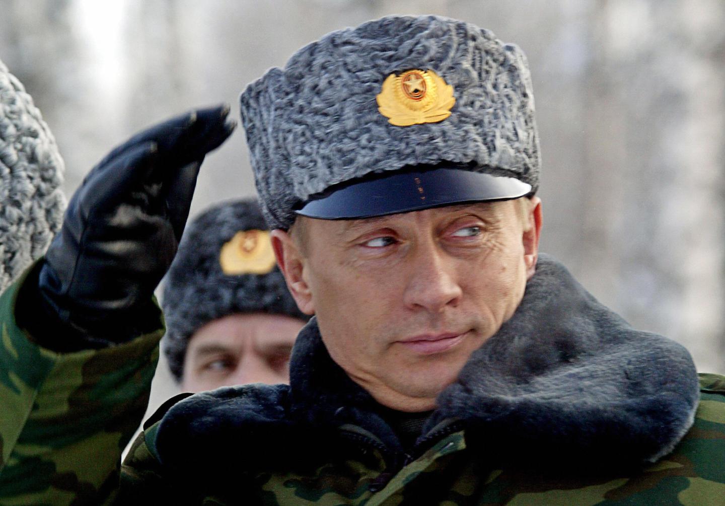 Russian President Vladimir Putin salutes
