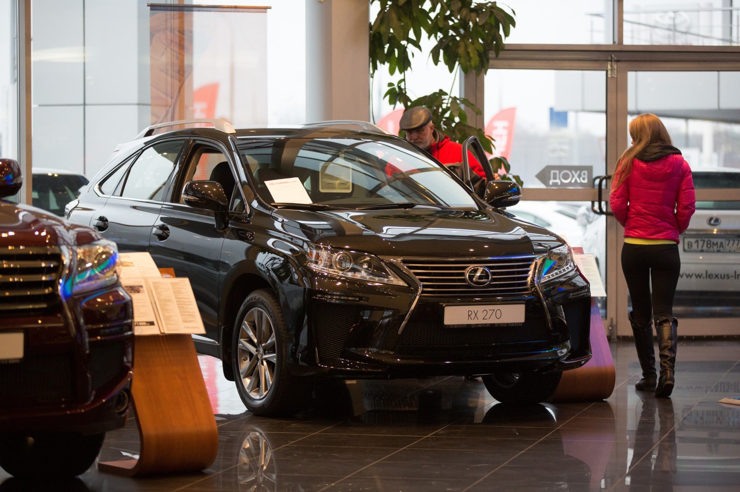 A customer checks out the interior of a Lexus RX270 vehicle for sale inside a Lexus automobile dealership, a unit of Toyota Motor Corp., in Moscow, Russia, on Tuesday, Dec. 16, 2014. Surging borrowing costs pile pressure on the economy of the world's biggest energy exporter, buckling under the weight of slumping crude prices and the impact of the sanctions imposed over the conflict in Ukraine. Photographer: Andrey Rudakov/Bloomberg