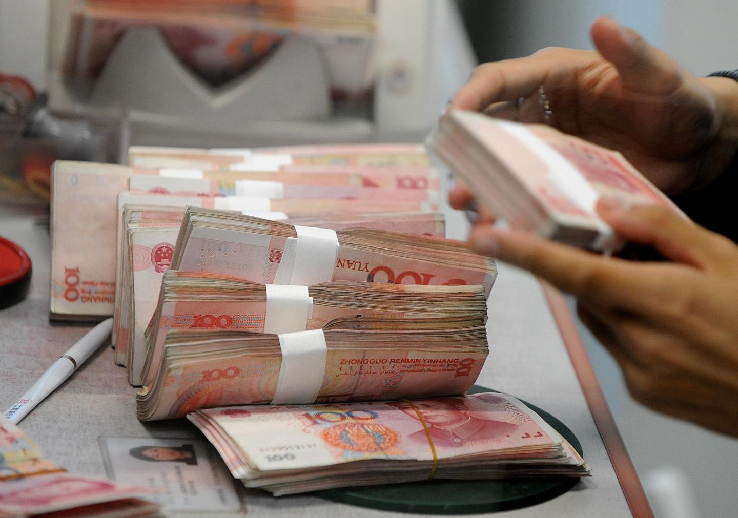 Chinese 100 Yuan notes are counted at a