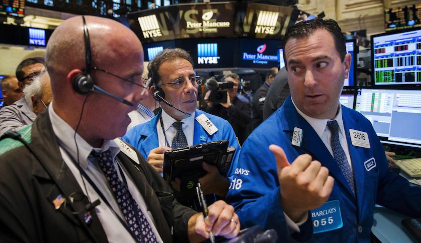 Traders on the floor of the New York Stock Exchange shortly after the opening bell in New York Wednesday