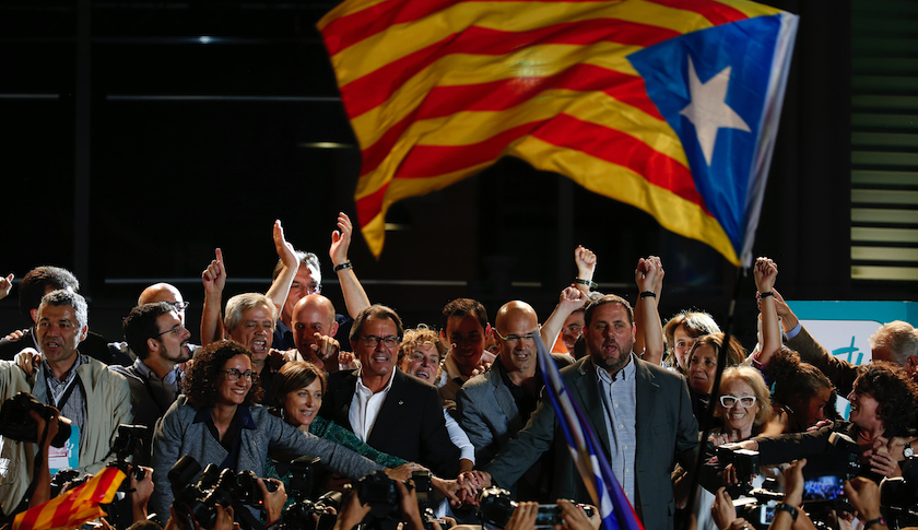 Catalan President Artur Mas (center left, glasses) joins hands with candidates for Junts pel Si after polls closed in Barcelona Sunday night.