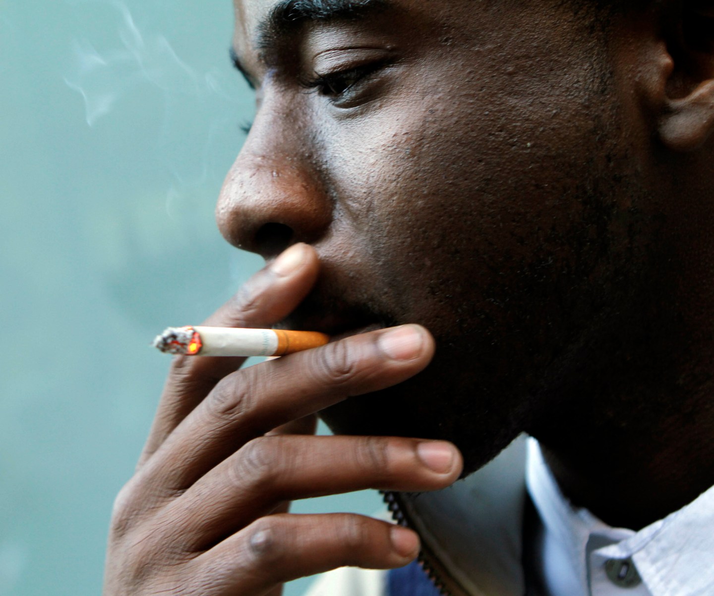 Samuel Johnson, 20, a student at Harold Washington College in the Loop, smokes a menthol cigarette outside while between classes.