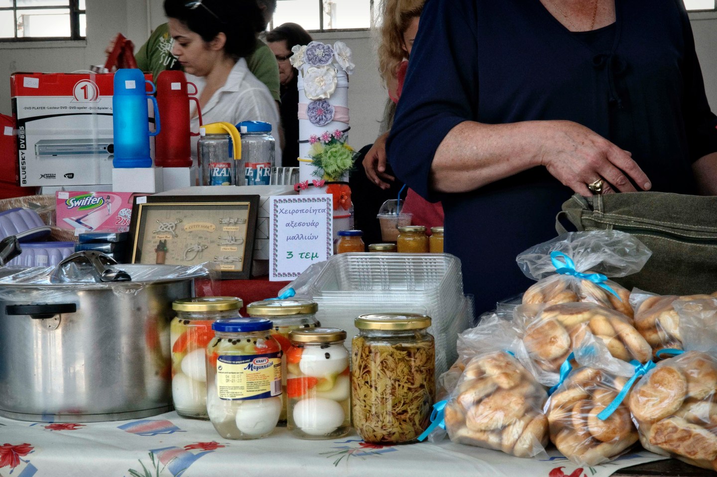 Women stand by their products at a bartering bazaar in the central Greece's city of Volos.