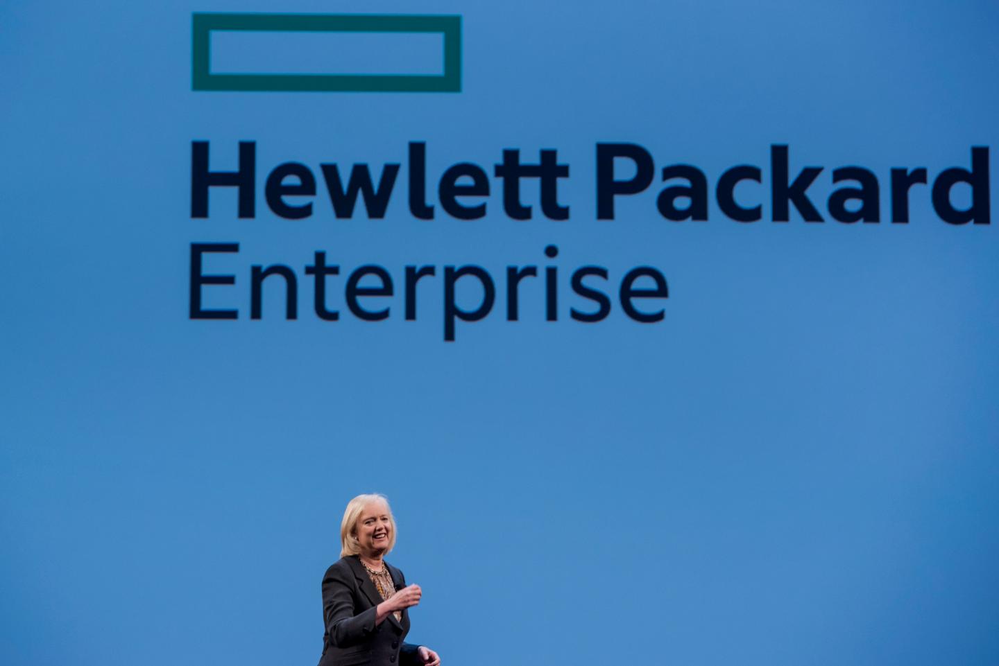 Meg Whitman, chief executive officer of Hewlett-Packard Co., speaks with the new Hewlett Packard Enterprise logo on the screen, during the HP Discover 2015 conference in Las Vegas, Nevada, U.S., on Tuesday, June 2, 2015. Hewlett-Packard Co. reported fiscal second-quarter profit that exceeded analysts' estimates as corporate spending on servers picked up ahead of the computer maker's planned separation into two companies. Photographer: David Paul Morris *** Local Caption *** Meg Whitman