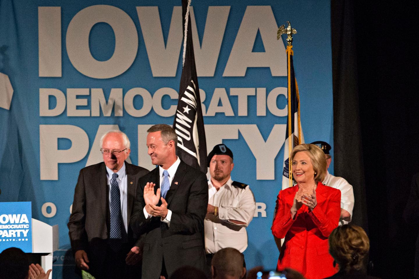 Hillary Clinton, former U.S. secretary of state and democratic candidate for U.S. president, right, Martin OÕMalley, former governor of Maryland and Democratic U.S. 2016 presidential candidate, center, and Senator Bernie Sanders, an independent from Vermont and Democratic U.S. 2016 presidential candidate, left, appear on stage together at the start of the Iowa Democratic Party Hall of Fame Celebration dinner in Cedar Rapids, Iowa, U.S., on Friday, July 17, 2015. Photographer: Daniel Acker/Bloomberg *** Local Caption *** Hillary Rodham Clinton; Martin O'Malley; Bernie Sanders