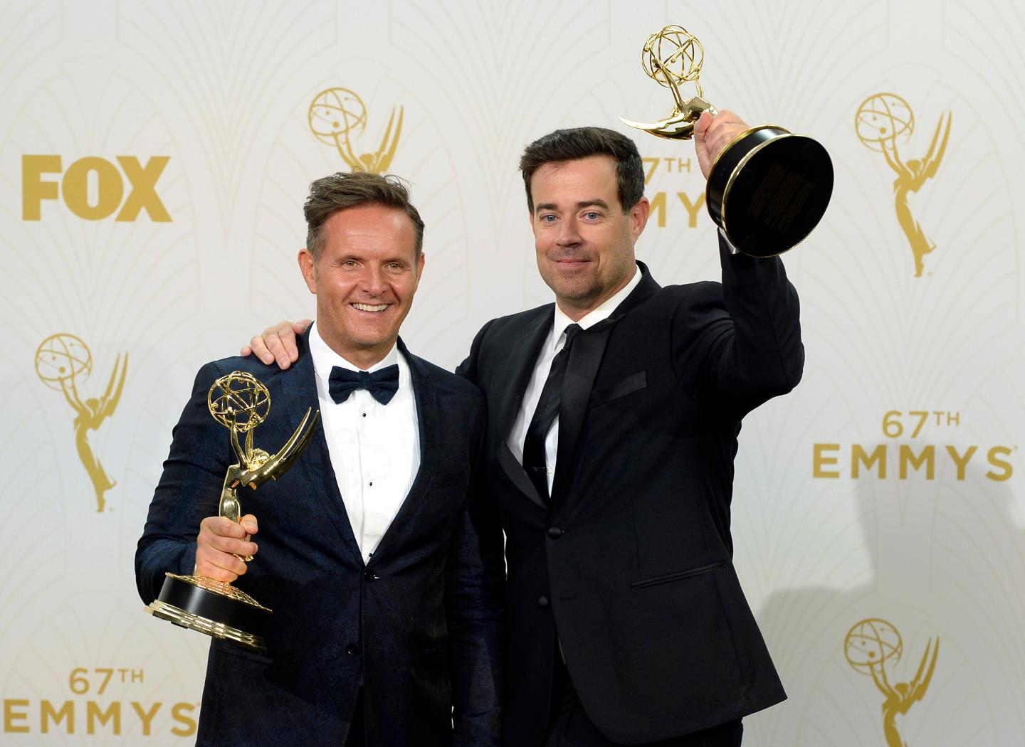 LOS ANGELES, CA - SEPTEMBER 20:  Producer Mark Burnett (L) and TV personality Carson Daly, winners of Outstanding Reality-Competition Program for 'The Voice', pose in the press room at the 67th Annual Primetime Emmy Awards at Microsoft Theater on September 20, 2015  in Los Angeles, California. (Photo by Kevork Djansezian/Getty Images)