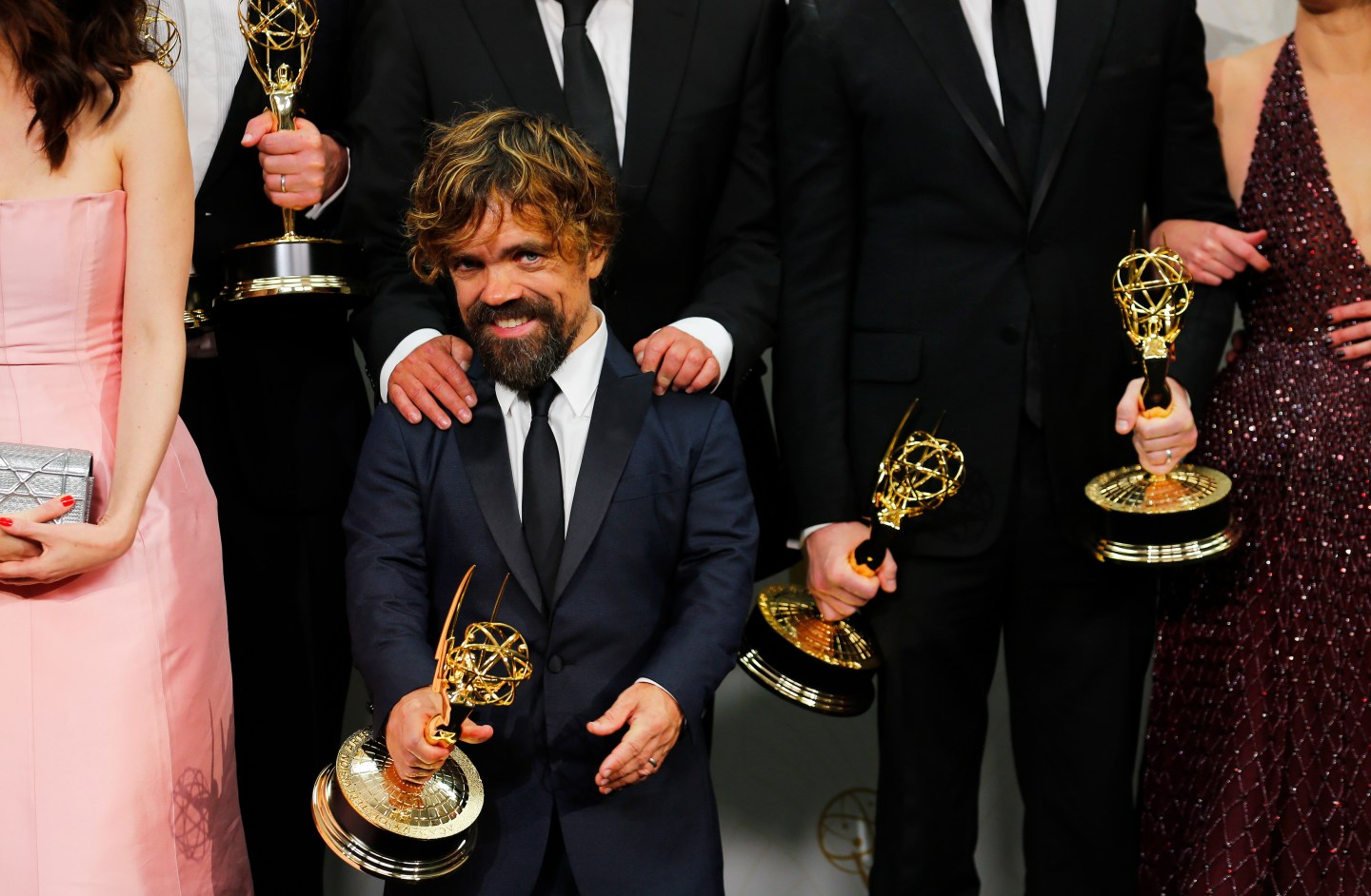 Peter Dinklage and the cast of the "Game of Thrones" pose backstage with their Outstanding Drama Series award during the 67th Primetime Emmy Awards in Los Angeles