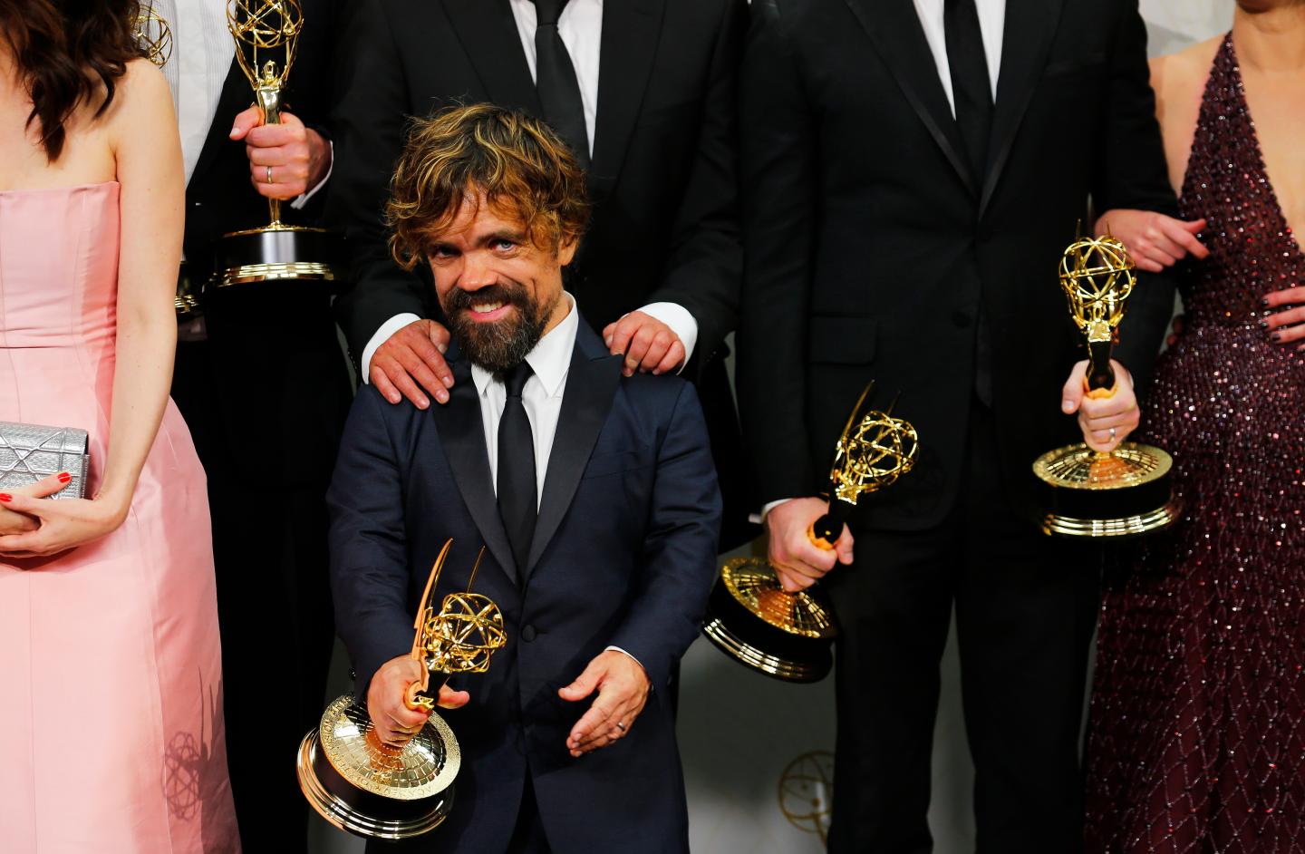 Peter Dinklage and the cast of the "Game of Thrones" pose backstage with their Outstanding Drama Series award during the 67th Primetime Emmy Awards in Los Angeles