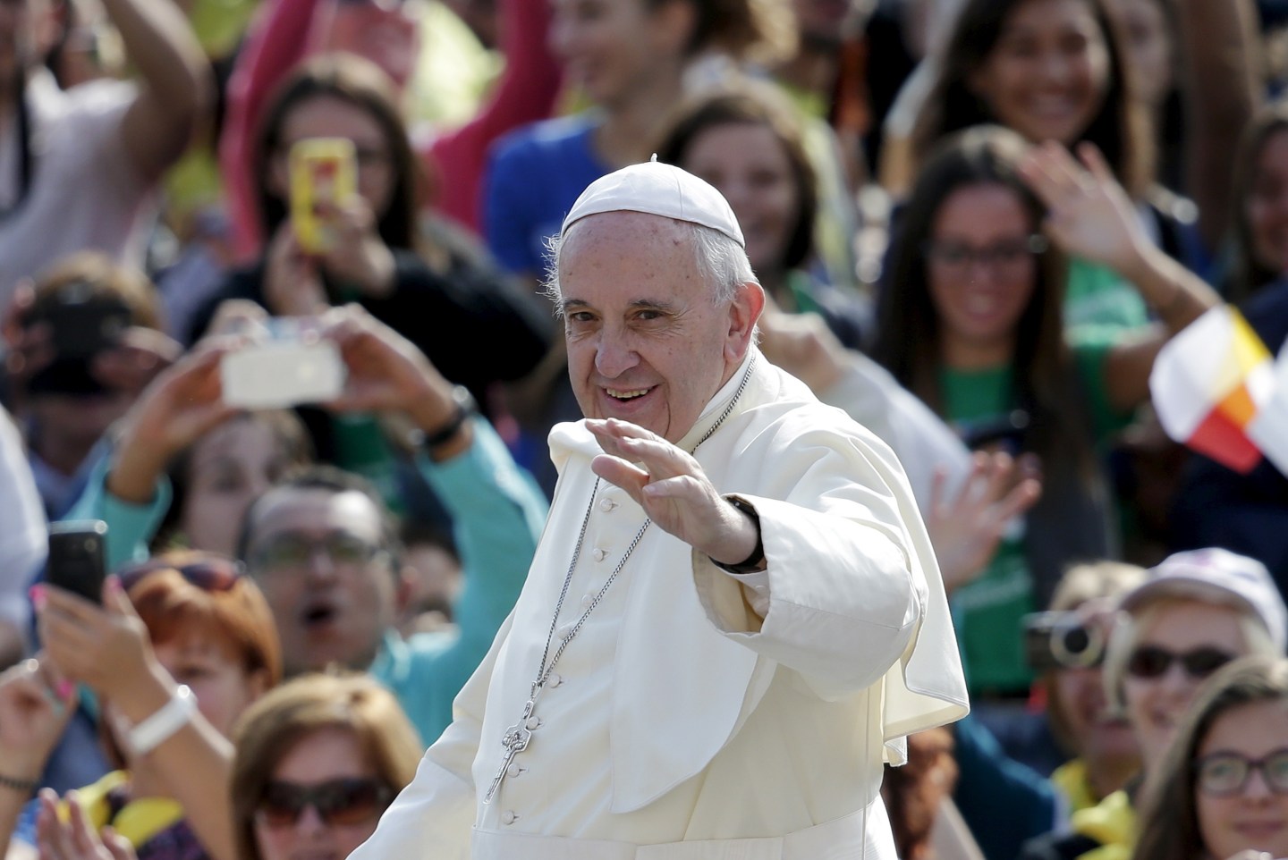 Pope Francis waves as he arrives to lead his Wednesday general audience in Saint Peter's Square at the Vatican