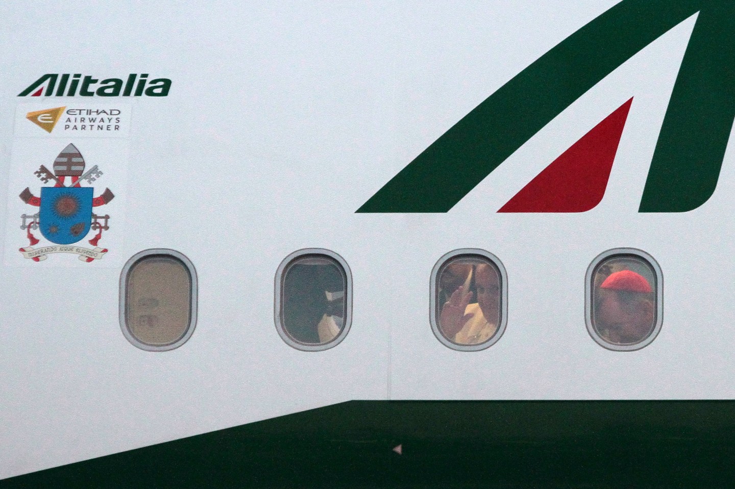 Pope Francis waves through window of airplane at the Sarajevo airport