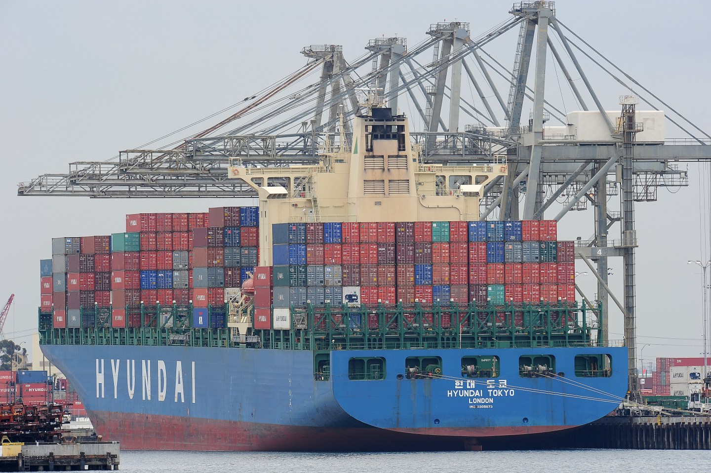 A container ship being unloaded is visib