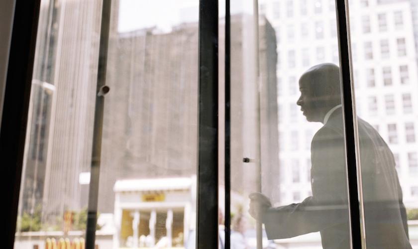 Businessman pushing through revolving doors