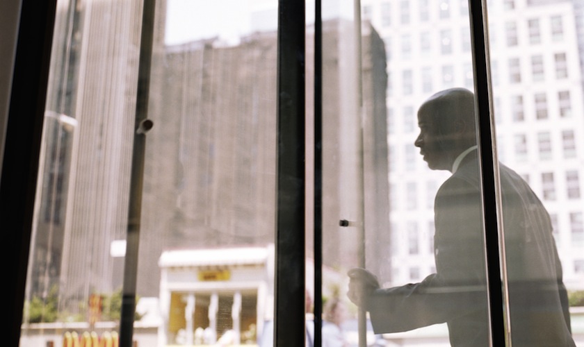 Businessman pushing through revolving doors