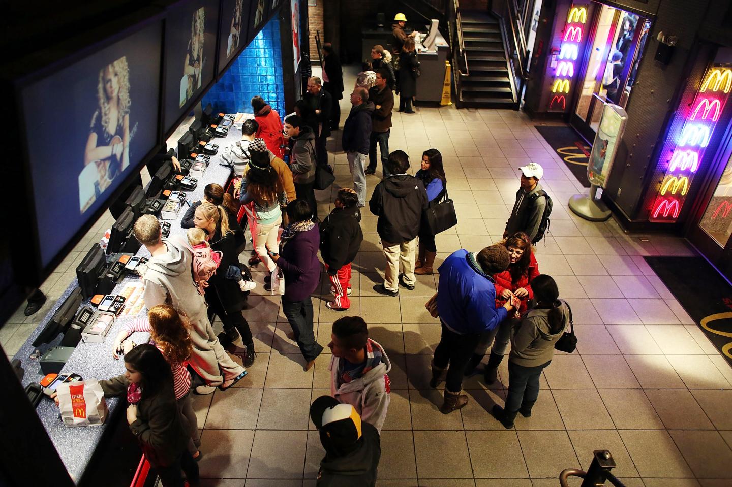 People stand in line at a McDonald's restaurant in Times Square in New York City. 