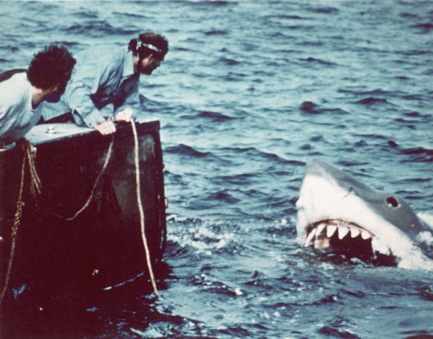 Caption:American actor Richard Dreyfuss (left) (as marine biologist Hooper) and British author and actor Robert Shaw (as shark fisherman Quint) look off the stern of Quint's fishing boat the 'Orca' at the terrifying approach of the mechanical giant shark dubbed 'Bruce' in a scene from the film 'Jaws' directed by Steven Spielberg, 1975. The movie, also starring Roy Scheider and Lorraine Gary, was one of the first 'Summer Blockbuster' films. (Photo by Universal Pictures courtesy of Getty Images)
