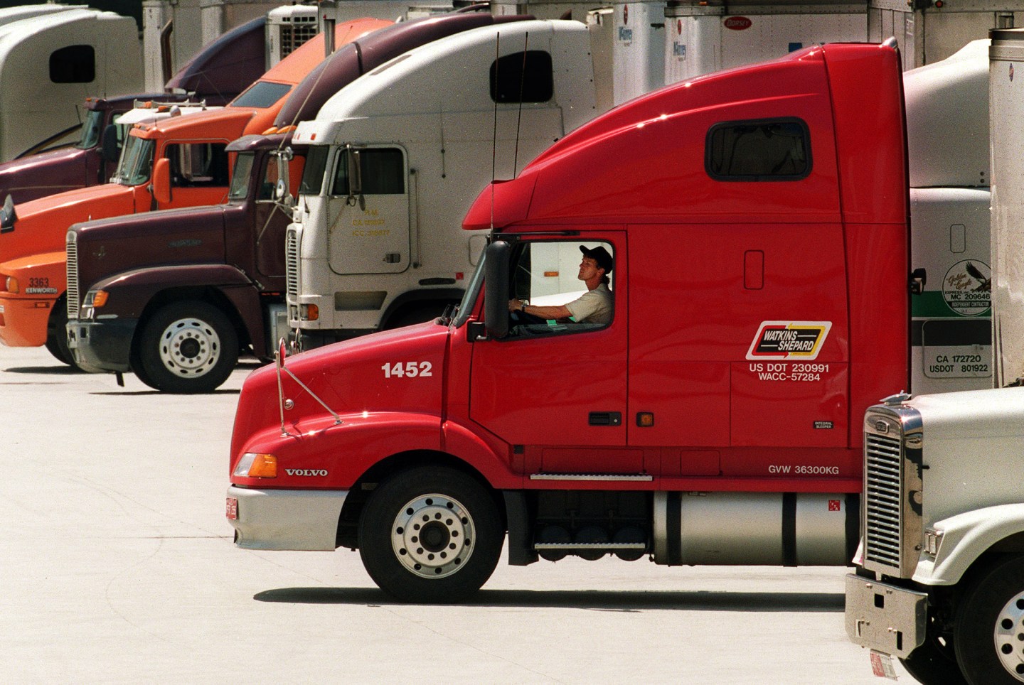 A trucker backs up his rig at a supermarket in Los Angeles.