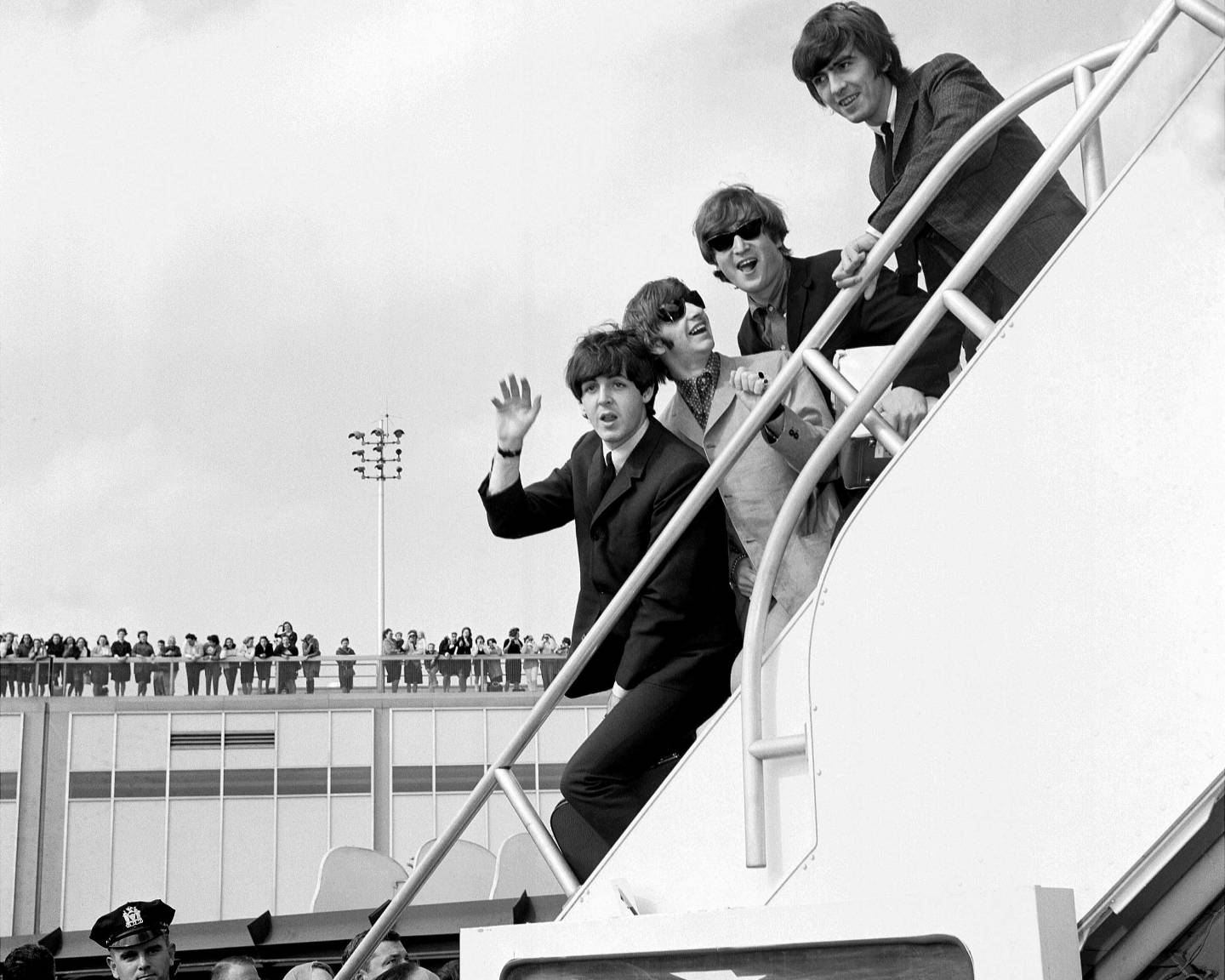 Fans line the rooftop at Kennedy International Airport for a