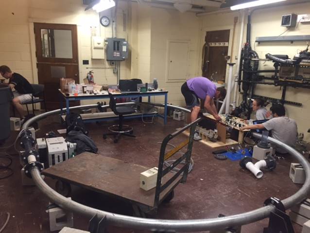 Students building a scale-model hyperloop