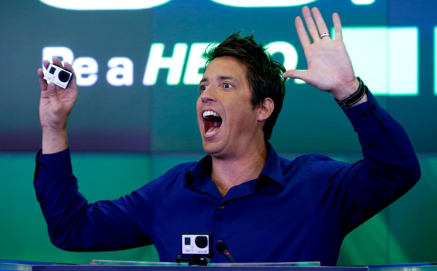 GoPro Inc's founder and CEO Woodman holds a GoPro camera as he celebrates GoPro Inc's IPO at the Nasdaq Market Site in New York