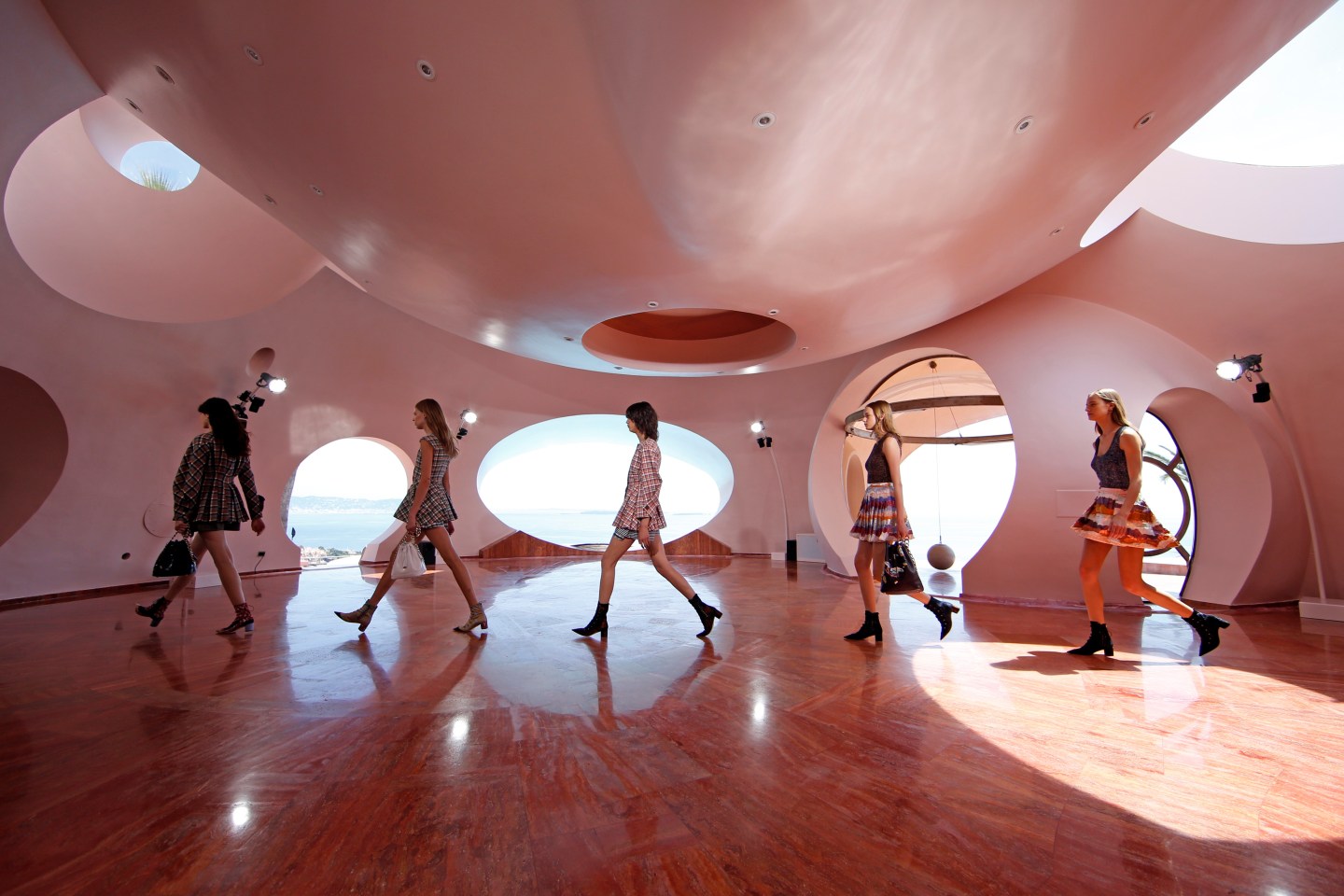 Models present creations by Belgian designer Raf Simons for Dior's women CRUISE 2016 collection during a fashion show at the Palais Bulle in Theoule-sur-Mer, near Cannes