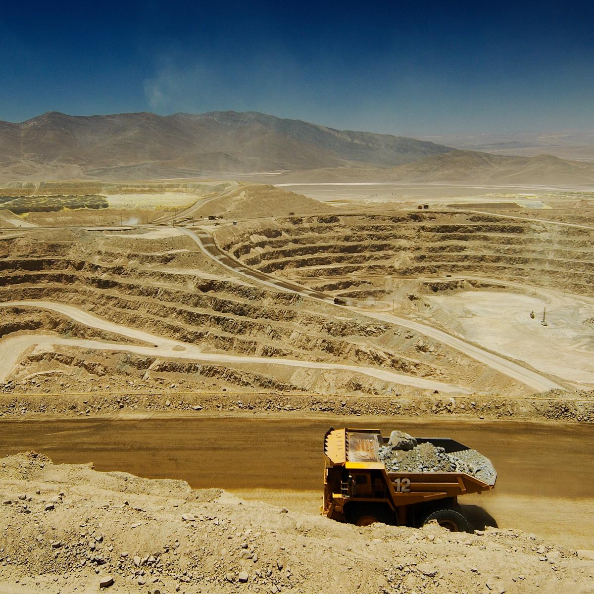 A truck hauls ore at Lomas Bayas open pit mine, Chile