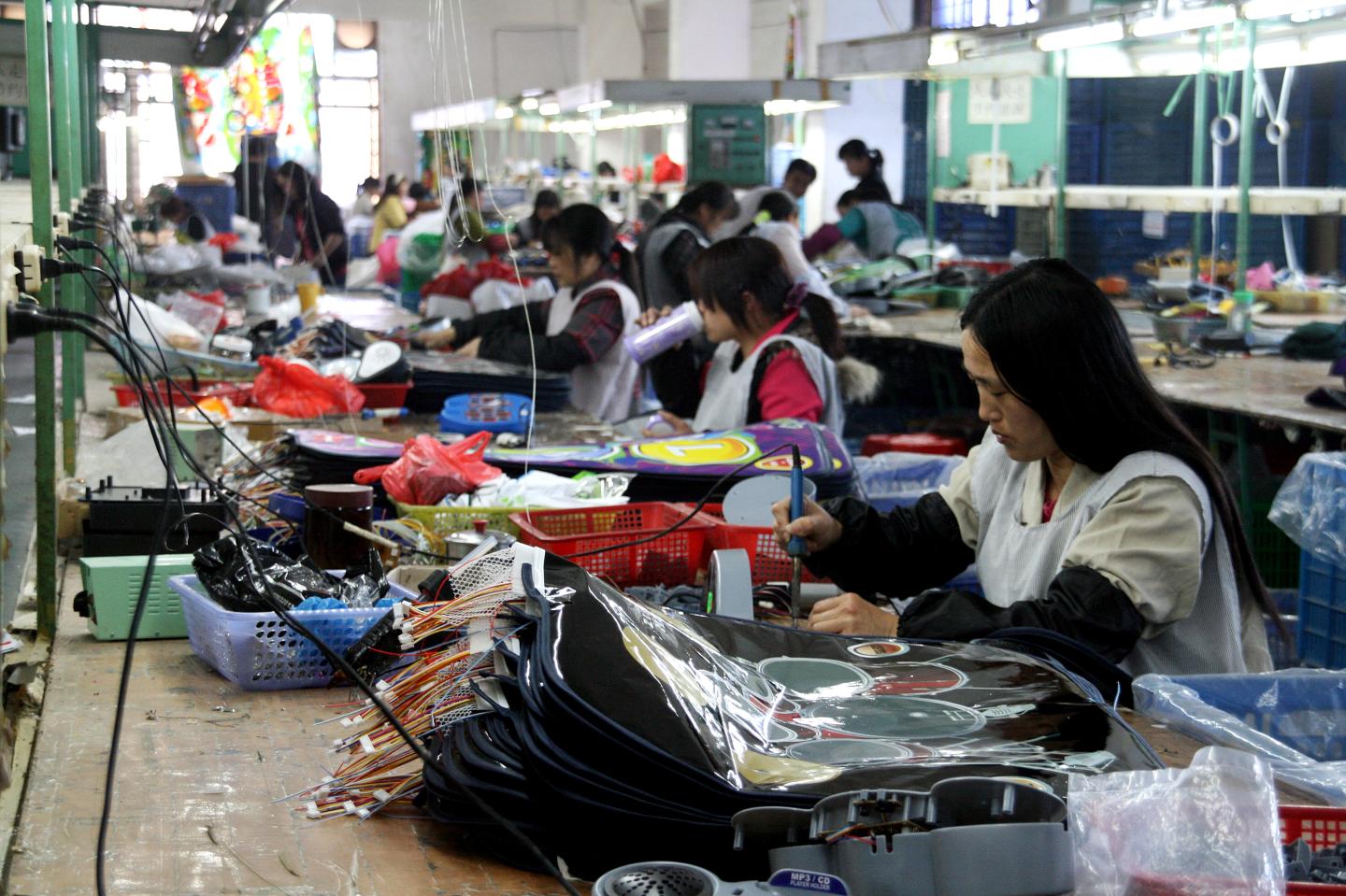 Workers make various toys and games at a